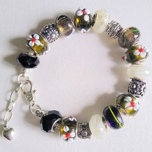 All Charmed Up - Fine Metal Charm Bracelet with Lampwork glass beads in design.